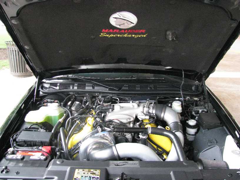 2003 Mercury Marauder engine bay showing supercharger and intake plumbing