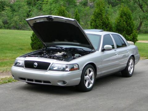 1997 Mercury Grand Marquis - Silver sedan with the hood open, revealing the engine compartment and a sunroof.
