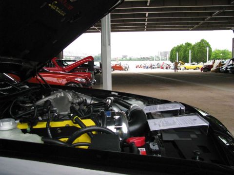 2003 Mercury Marauder - Multiple vehicles are displayed under a covered area, with one car's engine prominently featured.