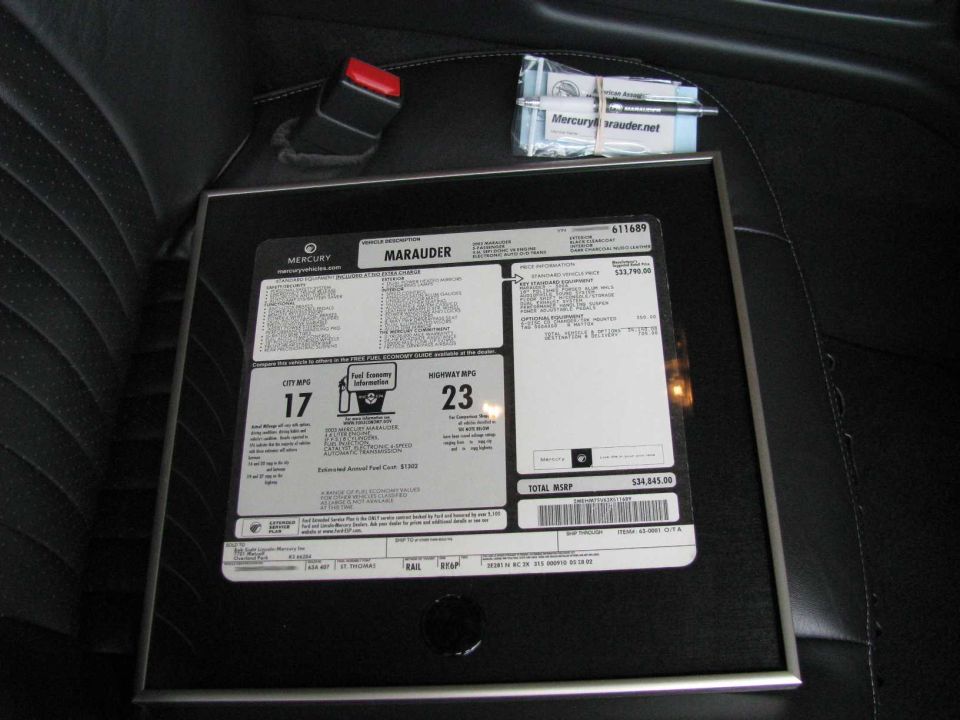 Framed Mercury Marauder window sticker showing 17 city and 23 highway MPG ratings and total MSRP