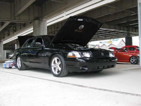 2003 Mercury Marauder - A black 2003 Mercury Marauder is parked with its hood and trunk open, with another car visible in the background.