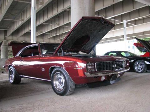 2003 Mercury Marauder - A maroon 1969 Chevrolet Camaro SS 396 is displayed with its hood open, alongside another vehicle.