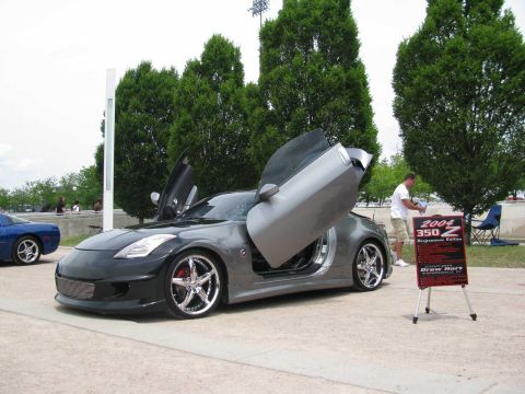 2003 Mercury Marauder - A customized 2004 Nissan 350Z is displayed with its doors open, next to a sign detailing its features.