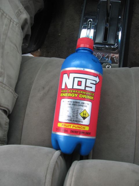 1988 Mercury Grand Marquis - A NOS energy drink sits on the passenger seat of a car, next to the automatic transmission shifter.