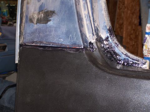 1986 Ford Bronco - A close-up view shows a section of a vehicle's body panel being worked on, with black sealant applied along a seam. The upper portion of th…