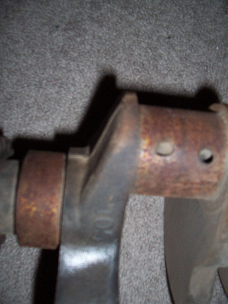 Close-up of a rusty cast metal vehicle part