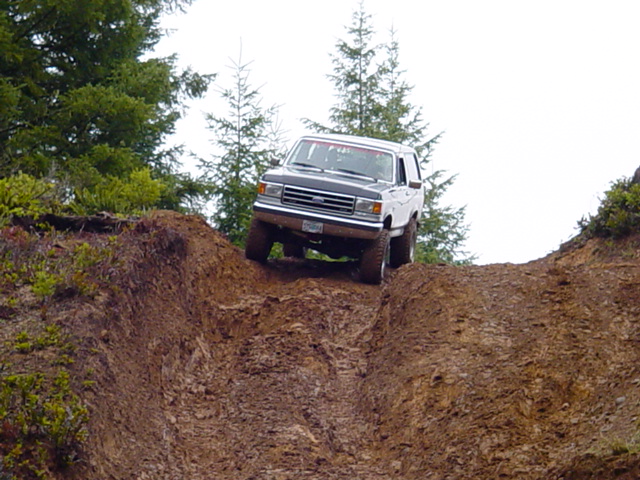 White and black SUV on a steep dirt incline