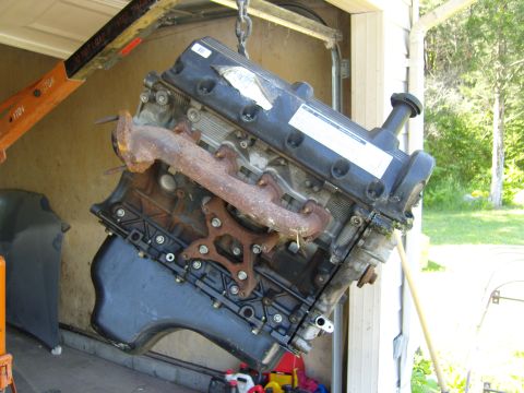 2007 Ford Mustang - Photograph of an engine suspended from a hoist, not a technical document.