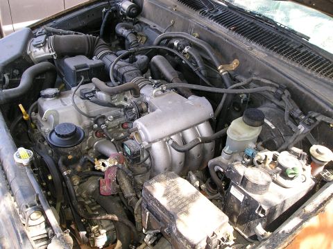 1986 Toyota Hilux - Close-up view of a vehicle's engine compartment, showing various components and wiring.