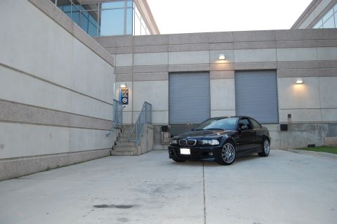 2002 BMW M3 - A motorcycle is parked indoors in a modern architectural space.
