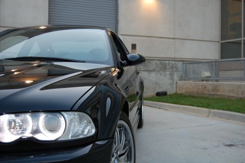 2002 BMW M3 - A black BMW M3 is parked in front of a concrete building.