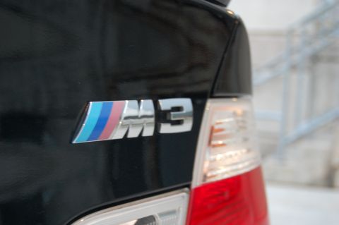 2002 BMW M3 - Close-up of the M3 badge on the rear of a black BMW, indicating the model and performance trim.