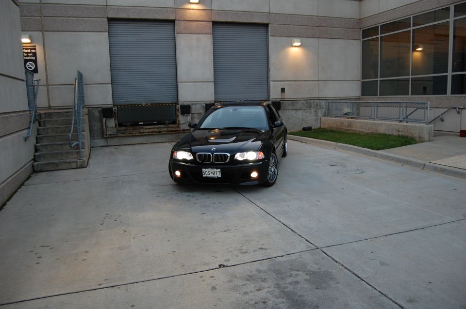 Black BMW M3 parked in front of a building