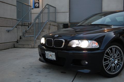 2002 BMW M3 - The front end of a black BMW M3 is captured in this image, showing its distinctive grille and headlights.
