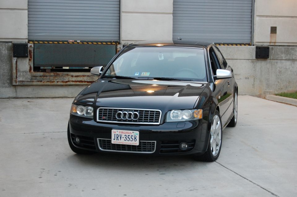 Black Audi S4 parked in front of a loading dock