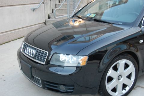 2002 BMW M3 - Front view of a black Audi A4, highlighting its grille and headlight assembly.