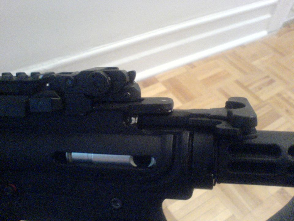 Black firearm receiver with rail system and rear sight