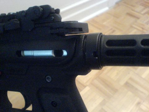 1985 Ford Bronco - Close-up view of a firearm receiver, showing the charging handle mechanism.