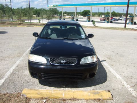2000 Nissan Sentra - Front view of a black 2000 Nissan Sentra, identified by its grille and overall body style, parked in a parking lot.