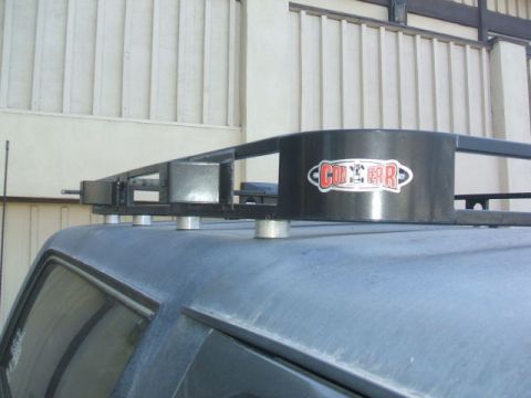 1988 Ford Bronco - A close-up shot of a vehicle's roof rack, a prominent 'CON-FERR' sticker on a cylindrical component.