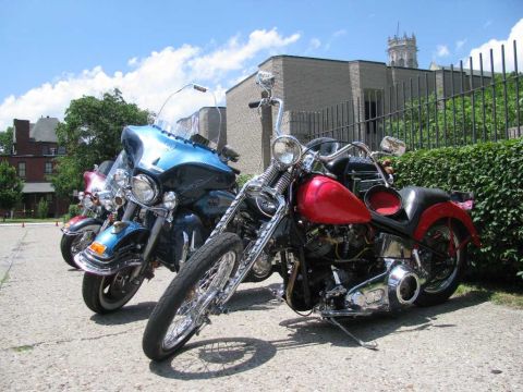 2003 Mercury Marauder - Several motorcycles are parked outdoors on a sunny day.