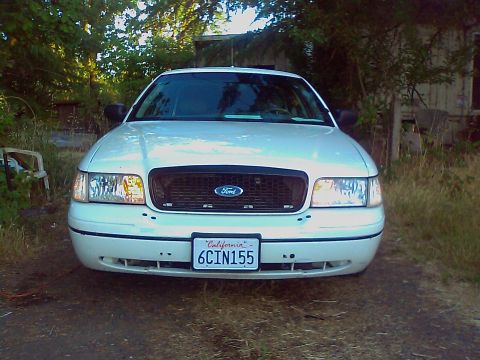 2000 Ford Crown Victoria - Front view of a white Ford Crown Victoria with a black grille and California license plate.