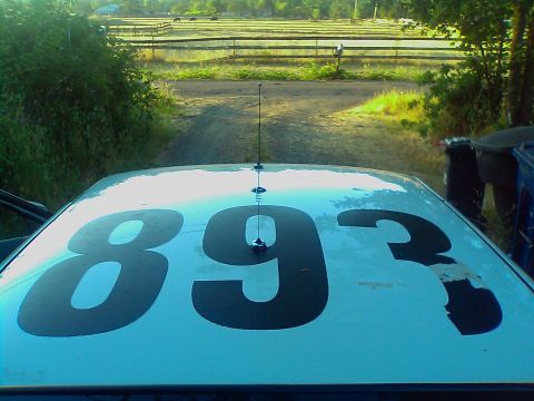 2000 Ford Crown Victoria - The roof of a car displays the numbers 893, with an antenna extending from the center.