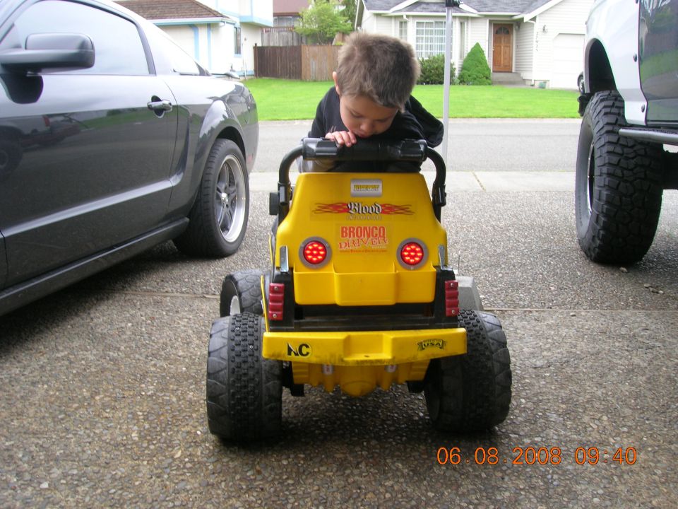 Yellow toy Bronco with 'Bronco Driver' text, rear view