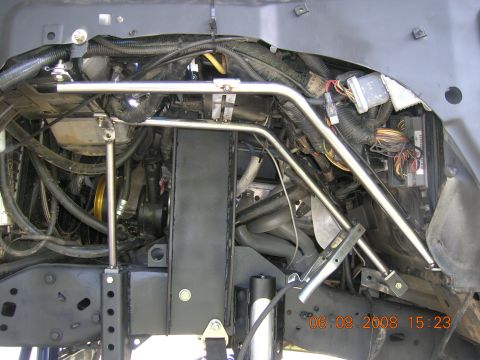 1996 Ford Bronco - Close-up view of a modified engine bay, showing custom structural reinforcements and extensive wiring.