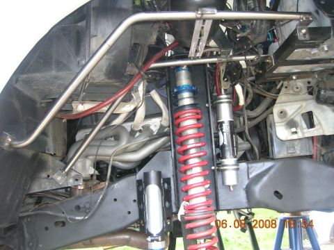 1996 Ford Bronco - Close-up view of a vehicle's modified suspension system and interior roll cage structure.