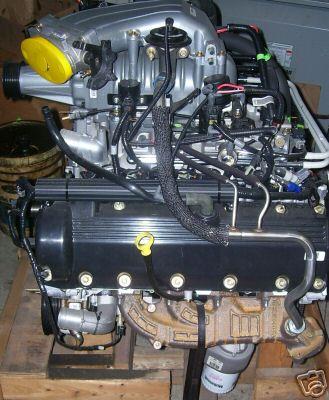 2007 Ford Mustang - Engine assembly, likely from a Ford vehicle, black valve covers and a silver intake manifold.