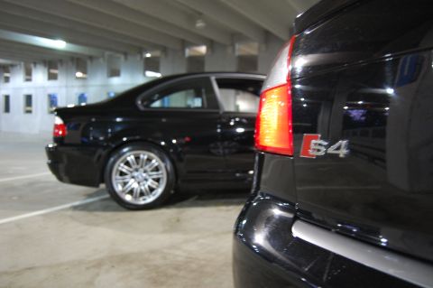 2002 BMW M3 - A black Audi S4 is in the foreground, with a black BMW M3 visible behind it in a parking garage.