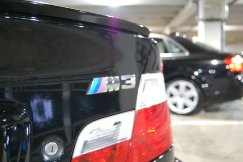 2002 BMW M3 - The iconic M3 badge is clearly visible on the rear of this black BMW, confirming it as a 2002 model.