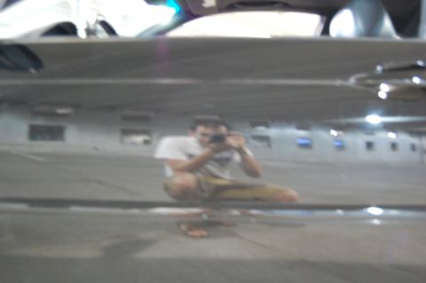2002 BMW M3 - A person is reflected in a dark, shiny surface, taking a picture of themselves.