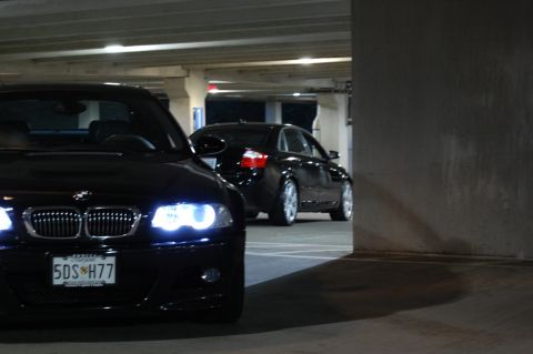 2002 BMW M3 - A black 2002 BMW M3 is parked in a garage, with another black sedan in the background.
