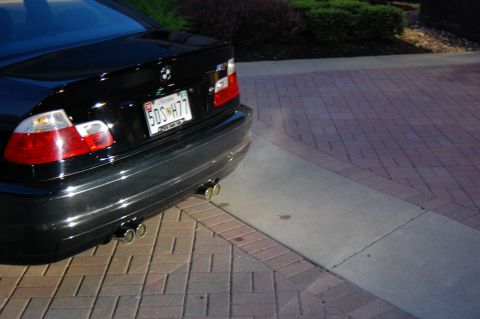 2002 BMW M3 - Rear view of a black BMW sedan, showing its dual exhaust and license plate.