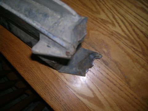 1996 Ford Bronco - Close-up of a broken metal part, possibly from a vehicle's suspension system.