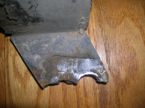 1996 Ford Bronco - A close-up view of a damaged metal component, showing signs of significant wear and tear.