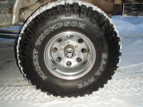 1992 Ford Bronco - Close-up of a Mickey Thompson Baja MTZ tire and wheel in the snow.