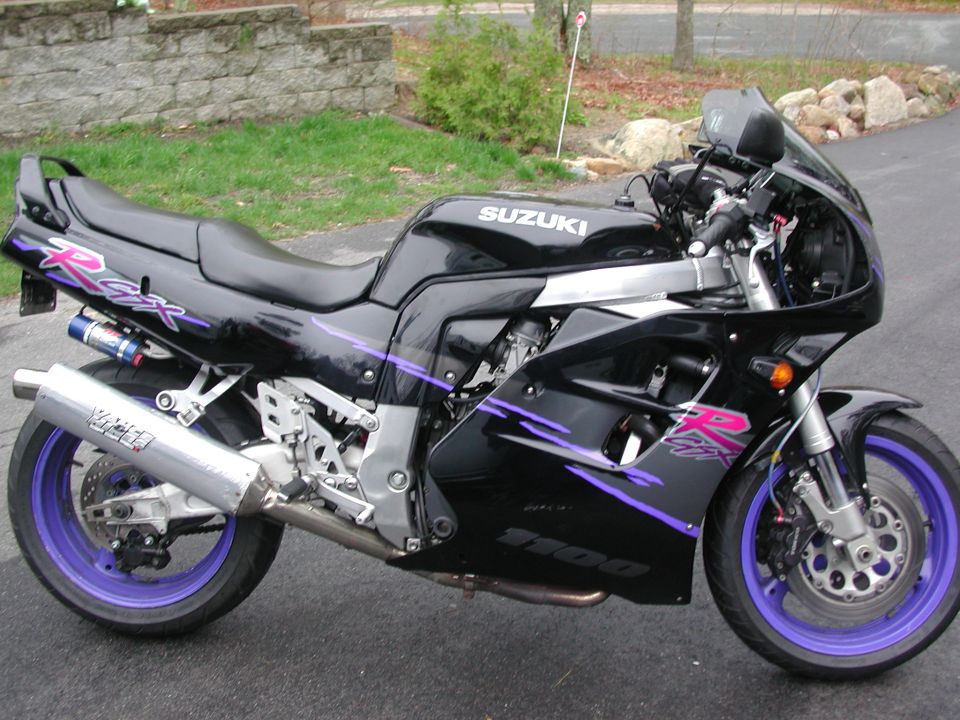 Black Suzuki GSX-R sportbike with purple wheels, pink graphics and aluminum slip-on exhaust