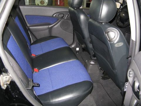 2003 Ford Focus - The interior of the vehicle features black leather seats with blue fabric inserts and black door panels.