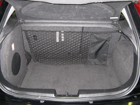 2003 Ford Focus - The cargo area of a 2003 Ford Focus features a net and side storage compartment.