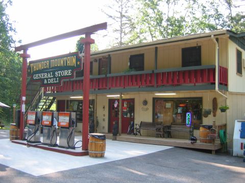1985 Ford LTD Crown Victoria - Thunder Mountain General Store & Deli is a roadside establishment with gas pumps and outdoor seating.