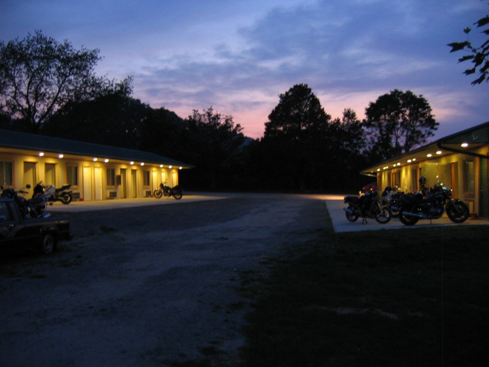 Motorcycles parked in front of a motel at dusk