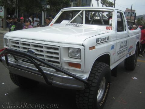 1984 Ford Bronco - This modified pickup truck features a roll cage and BFGoodrich tires, suggesting off-road use.