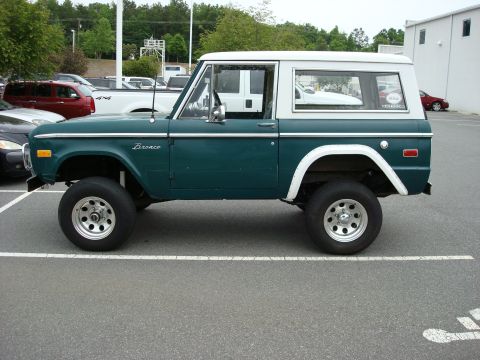 1977 Ford Bronco - This 1977 Ford Bronco is shown in a side profile, a two-tone green and white paint scheme and custom wheels.