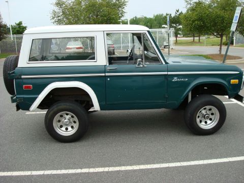 1977 Ford Bronco - 1977 Ford Bronco in side profile, showing its classic body style and two-tone paint scheme.