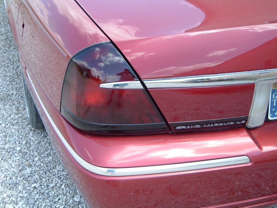 Smoke-tinted taillight on red Mercury Grand Marquis LS with GRAND MARQUIS LS badge