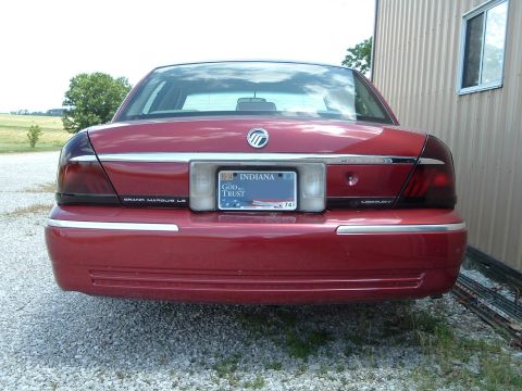 1999 Mercury Grand Marquis - Rear view of a red 1999 Mercury Grand Marquis LS sedan, the Indiana license plate and chrome trim.