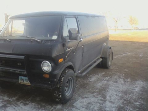 1992 Ford F-350 - Panel van with dual rear wheels sits parked outdoors in a dusty, possibly snowy, area.